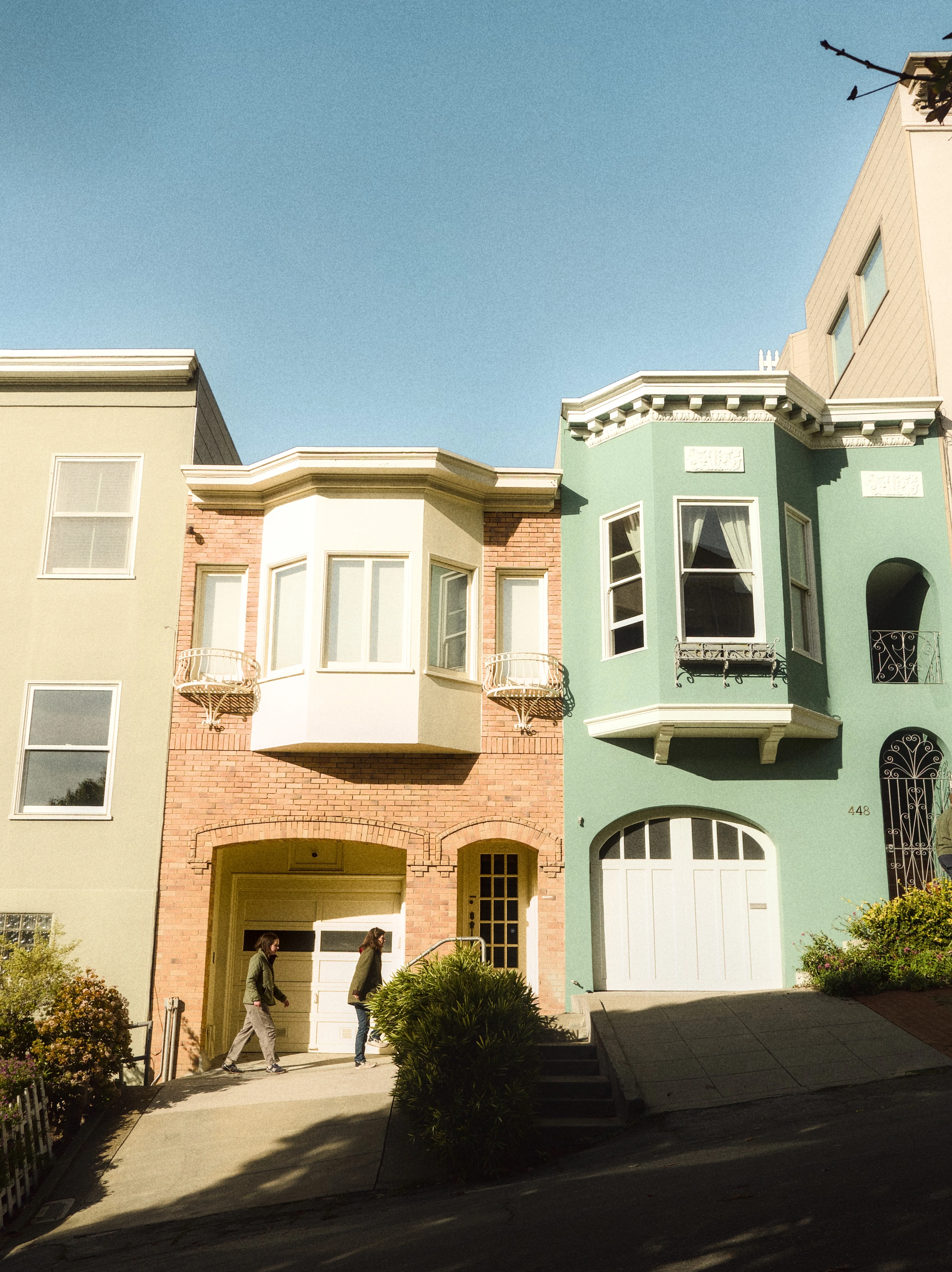 Uncropped photo of colorful San Francisco houses with extra sky and edge distractions.