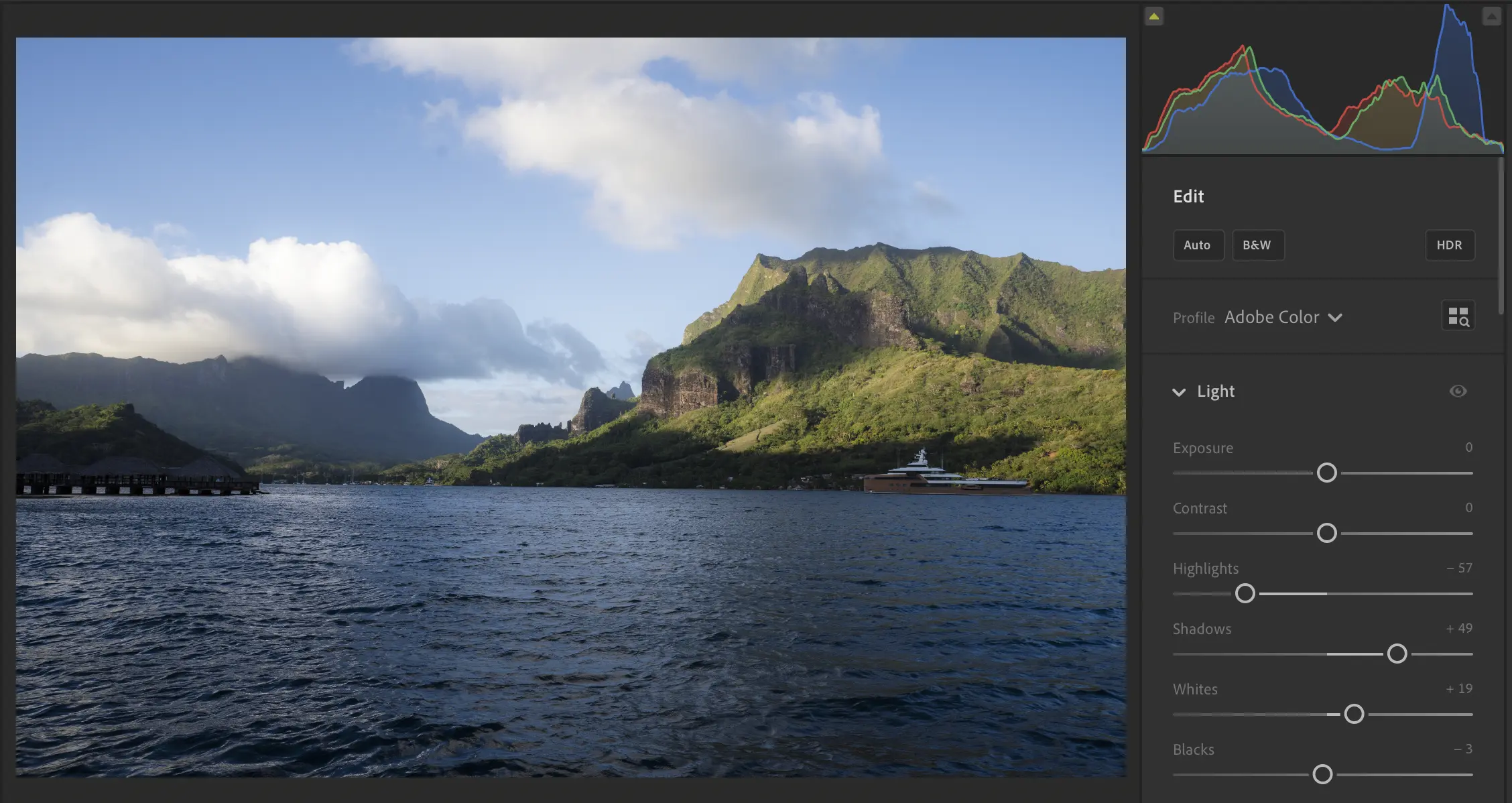 Lightroom-style editing interface with a landscape image, histogram, and light sliders.